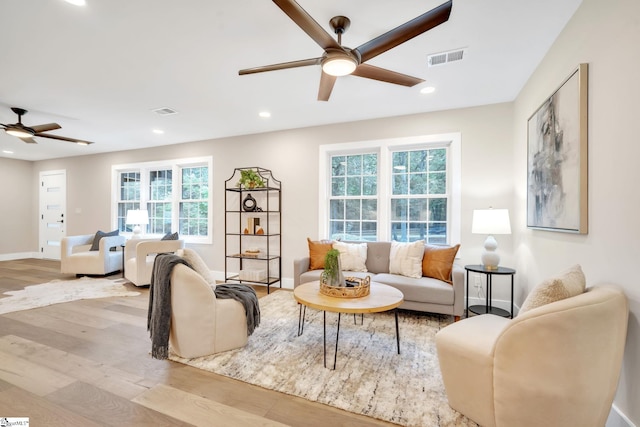 living room featuring plenty of natural light, light hardwood / wood-style floors, and ceiling fan