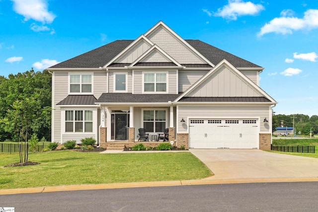 craftsman-style home with a garage, a front yard, and covered porch