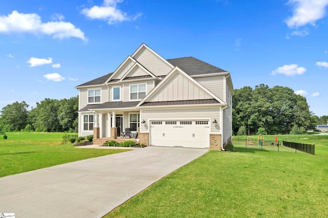 craftsman inspired home featuring a garage, covered porch, and a front lawn