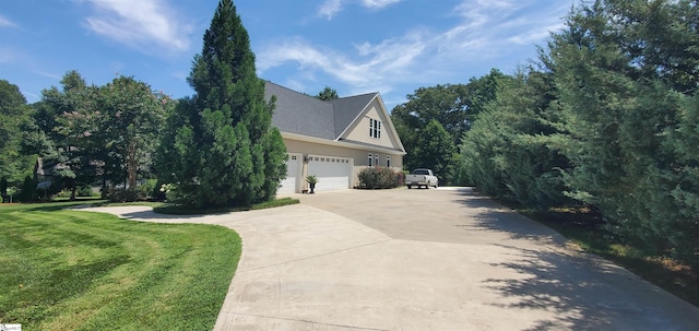 view of home's exterior with a garage and a lawn