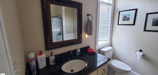 bathroom featuring vanity and toilet