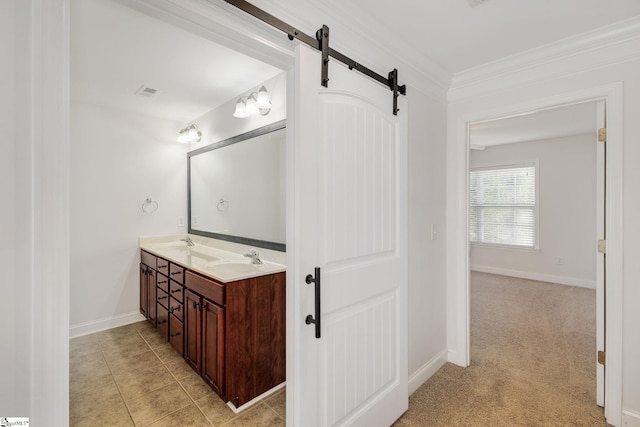 bathroom with dual vanity, tile patterned floors, and crown molding