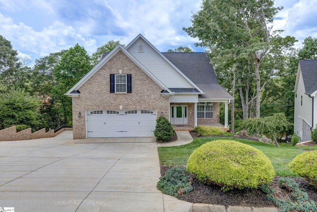 view of front of property with a garage and a front lawn