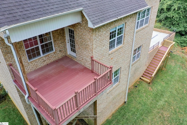 wooden deck featuring a yard