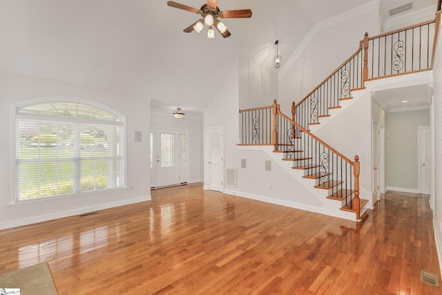 entrance foyer featuring high vaulted ceiling, crown molding, ceiling fan, and wood-type flooring