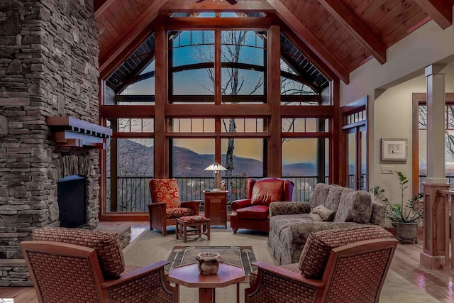 interior space with wood ceiling, lofted ceiling with beams, and ornate columns