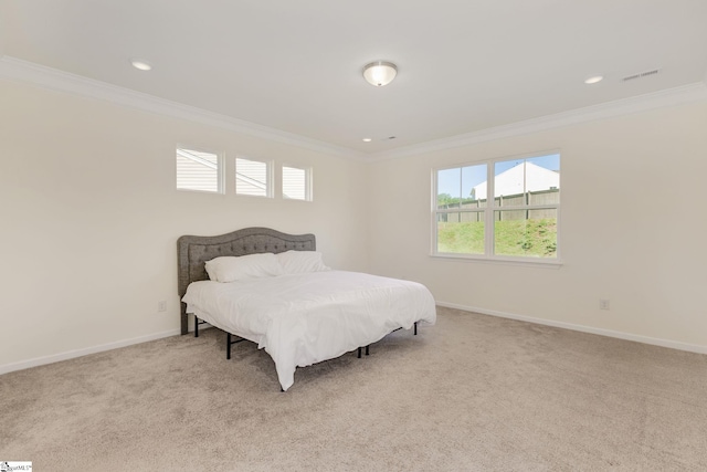 carpeted bedroom with ornamental molding