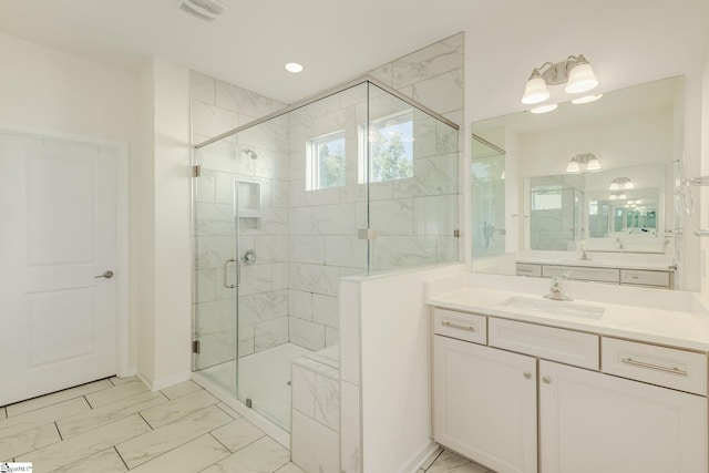 bathroom with tile patterned flooring, a shower with door, and vanity