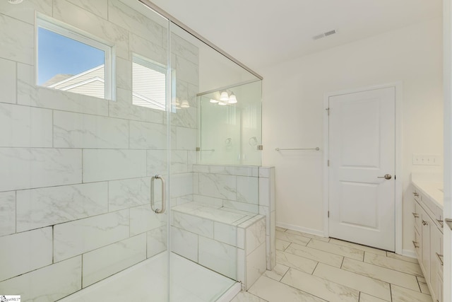 bathroom featuring tile patterned flooring, walk in shower, and vanity