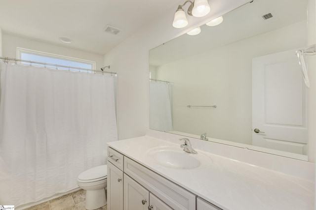 bathroom with vanity, tile patterned flooring, and toilet