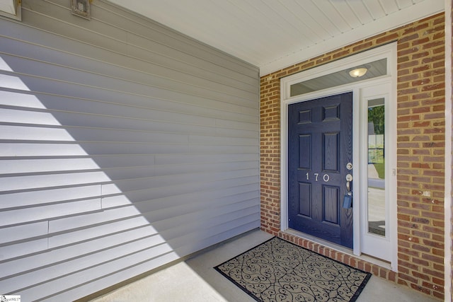 view of exterior entry with covered porch