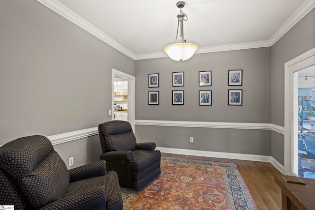 living area with crown molding and dark wood-type flooring