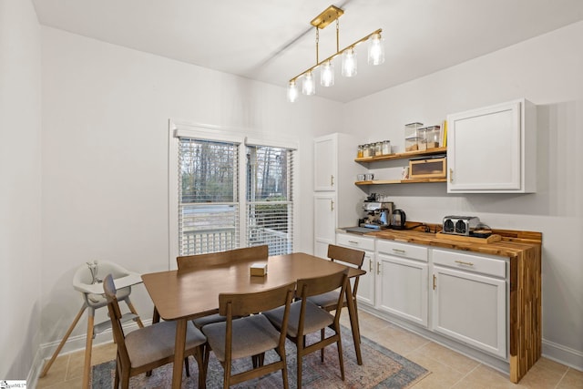 dining area featuring light tile patterned flooring