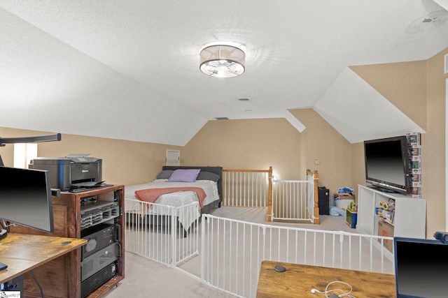carpeted bedroom featuring lofted ceiling and a textured ceiling