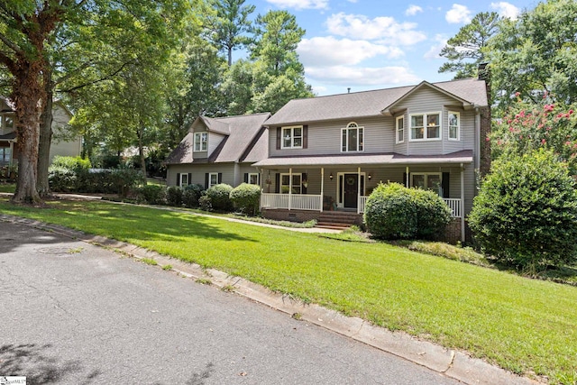 view of front of house with covered porch and a front yard