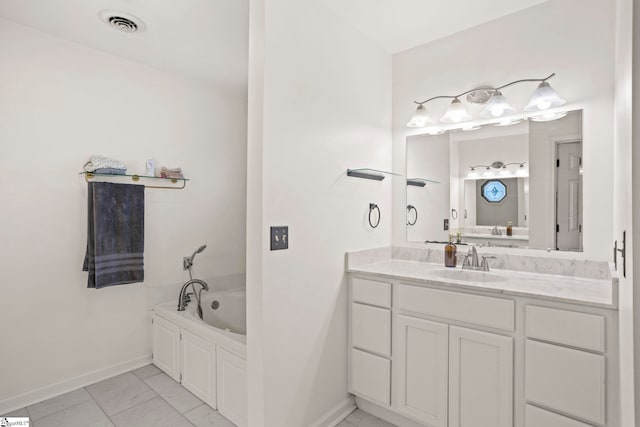 bathroom with vanity and a tub