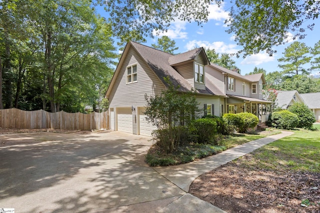 view of home's exterior featuring a garage and covered porch