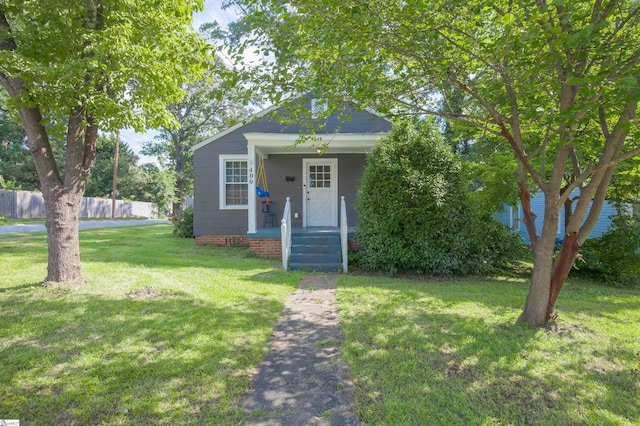 bungalow-style home featuring a front lawn