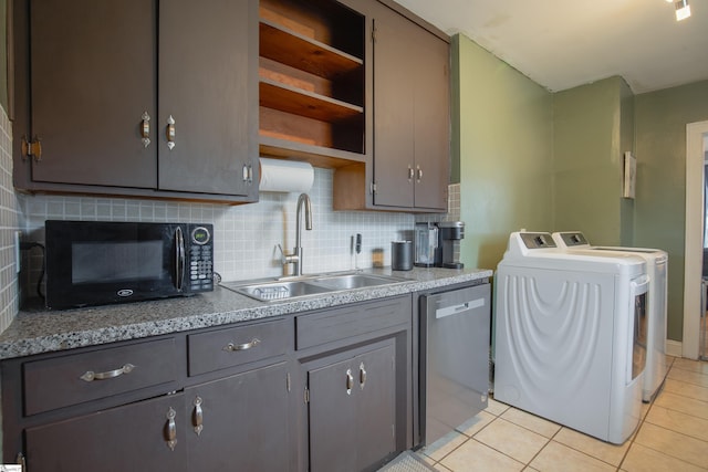 kitchen featuring sink, decorative backsplash, stainless steel dishwasher, washing machine and clothes dryer, and light tile patterned floors