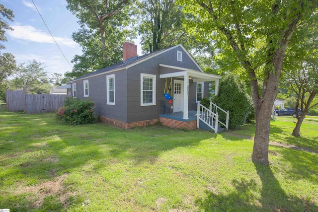 bungalow-style home with a front yard