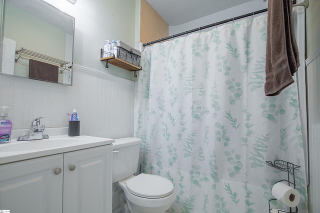 bathroom featuring vanity, toilet, and a shower with shower curtain