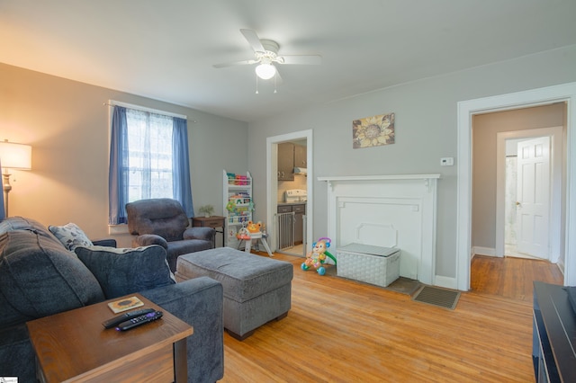 living room with hardwood / wood-style flooring and ceiling fan