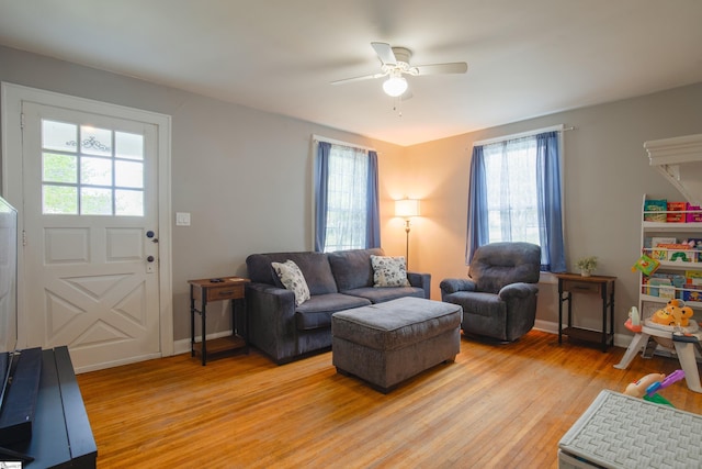 living room with ceiling fan and light hardwood / wood-style floors