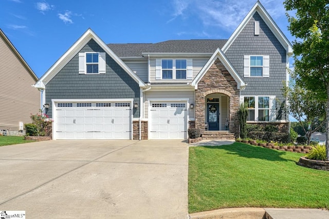 view of front of property with a garage and a front lawn