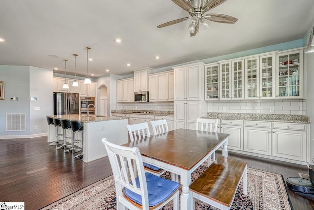 dining area with dark hardwood / wood-style flooring and ceiling fan