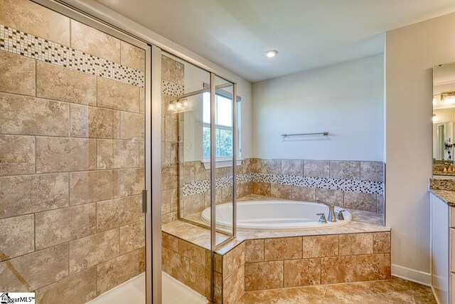 bathroom with tile patterned flooring, shower with separate bathtub, and vanity