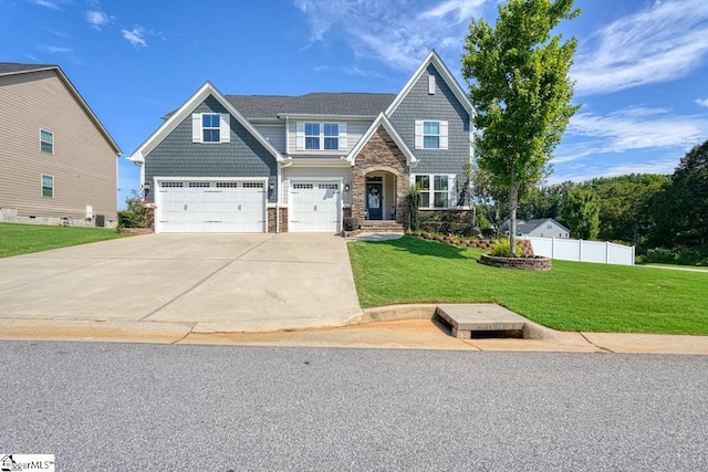 craftsman inspired home with a garage and a front lawn