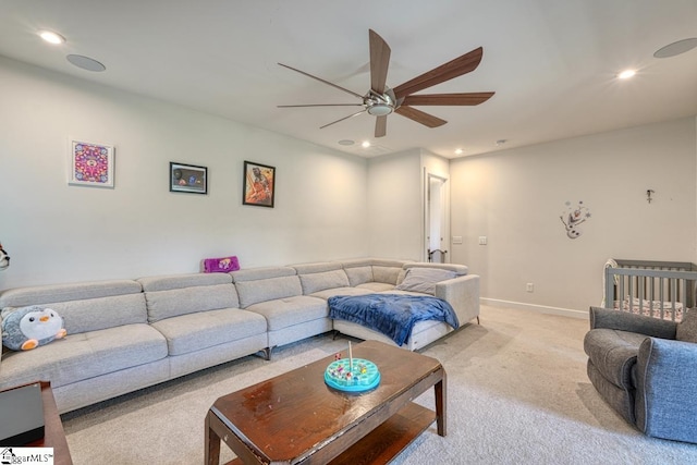 carpeted living room featuring ceiling fan