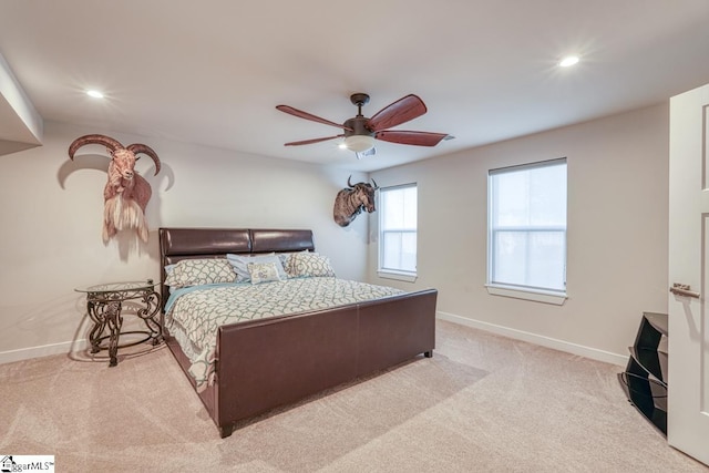 bedroom featuring light carpet and ceiling fan