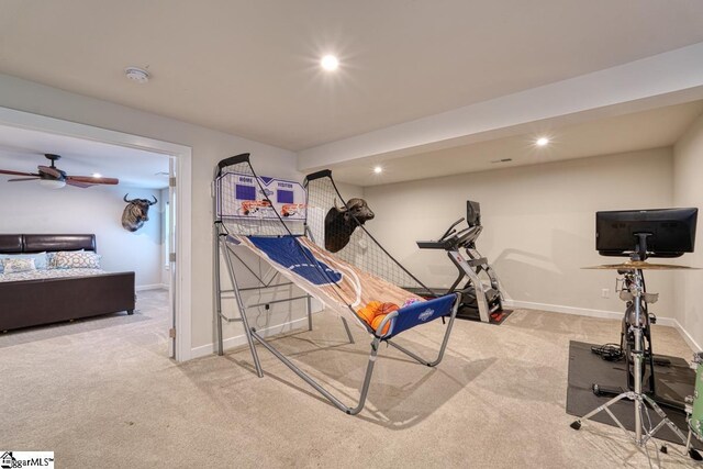 exercise room featuring light carpet and ceiling fan