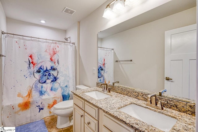 bathroom featuring tile patterned flooring, double sink vanity, and toilet