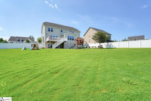 view of yard featuring a playground and a wooden deck