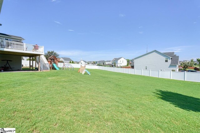 view of yard with a playground and a wooden deck