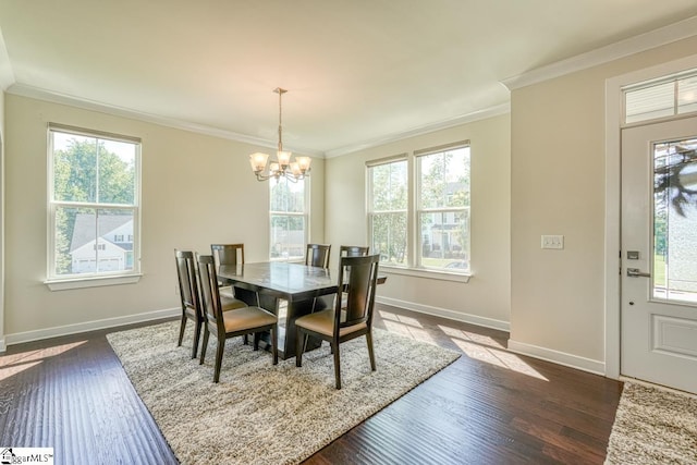 dining space featuring dark hardwood / wood-style flooring, crown molding, and plenty of natural light