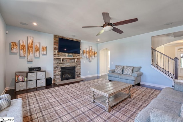 living room with a fireplace, ceiling fan, and hardwood / wood-style floors