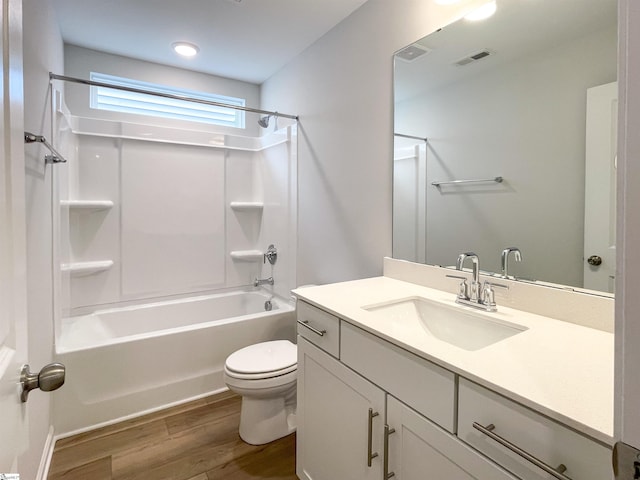 full bathroom with wood-type flooring, toilet, vanity, and shower / tub combination