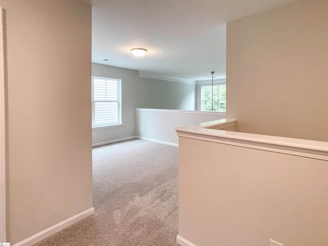 hall with light colored carpet