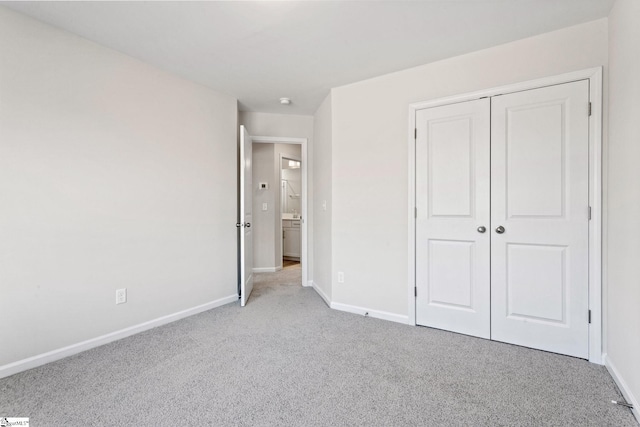 unfurnished bedroom featuring a closet and light carpet