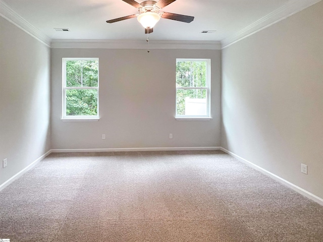 carpeted empty room featuring crown molding, plenty of natural light, and ceiling fan