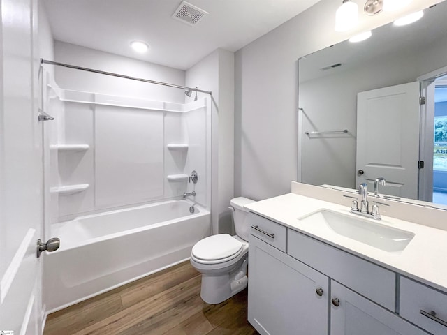 full bathroom with wood-type flooring,  shower combination, vanity, and toilet