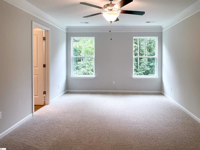 carpeted spare room featuring ceiling fan and ornamental molding