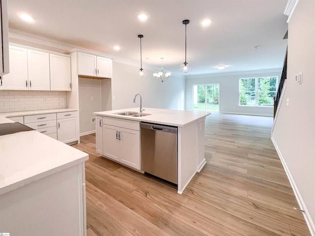 kitchen with dishwasher, light wood-style floors, tasteful backsplash, and a sink