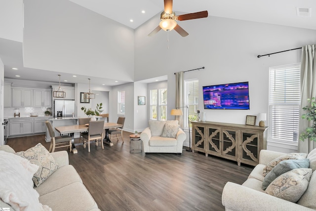 living room featuring ceiling fan, high vaulted ceiling, and dark wood-type flooring