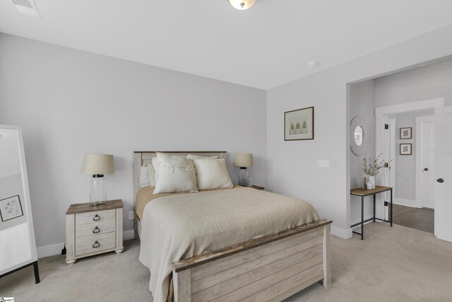 bedroom with light colored carpet