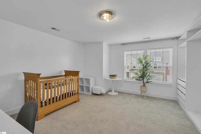 carpeted bedroom featuring visible vents and baseboards