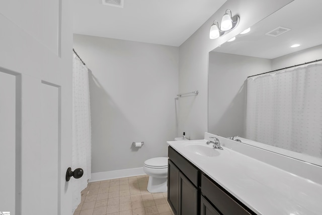 bathroom featuring vanity, toilet, and tile patterned floors